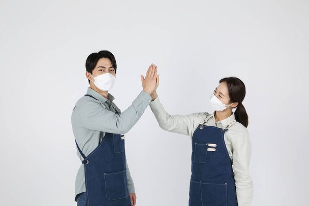 Asian Korean young man and woman startup concept High-five - Фото, изображение