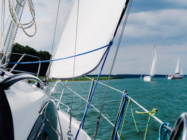 close up view on white sailing yacht or sailboat bow sailing on a lake - Фото, изображение