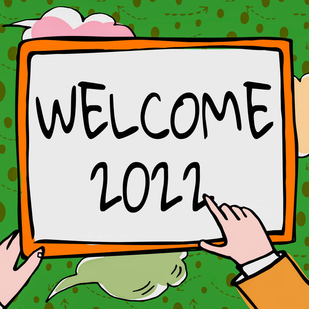 Sign displaying Welcome 2022. Internet Concept New Year Celebration Motivation to Start Cheers Congratulations Hands Holding Paper Showing New Ideas Surrounded With Stars. - Фото, изображение