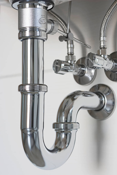 Close up of siphon under sink - Photo, image