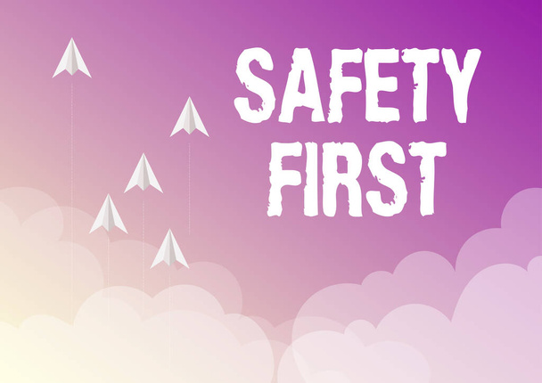 Inspiration showing sign Safety First. Word Written on Avoid any unnecessary risk Live Safely Be Careful Pay attention Five paper airplanes flying up sky surrounded with clouds achieving goals. - Fotó, kép