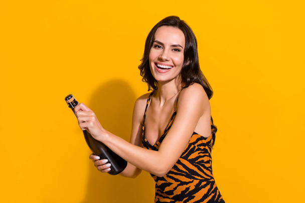 Profile side photo of young cheerful woman open bottle of wine festive isolated over yellow color background - Photo, Image