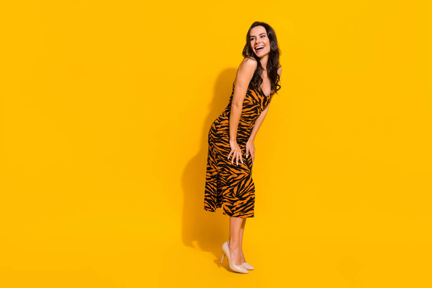 Full size profile side photo of young cheerful lady look empty space curious isolated over yellow color background - Fotoğraf, Görsel