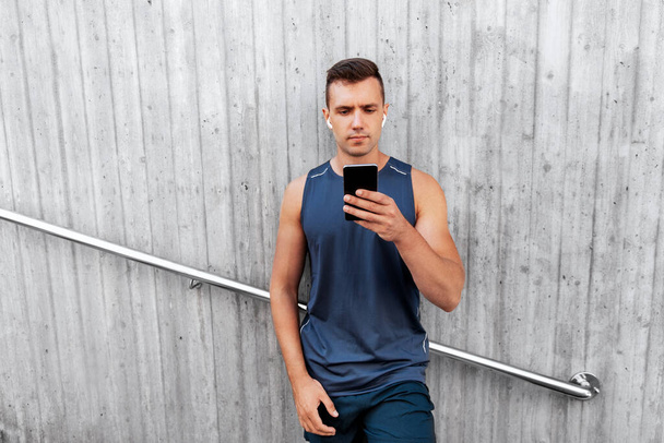 young athlete man with earphones and smartphone - Photo, image
