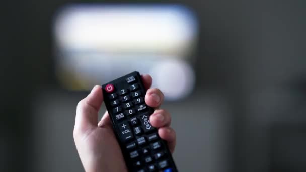 Hand Holding TV Remote Control And Turns Off TV - Footage, Video