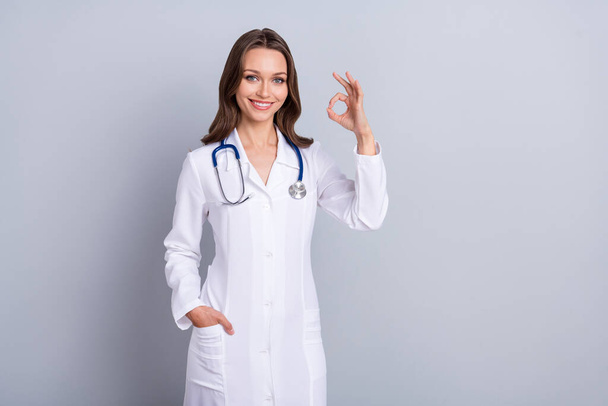 Photo of qualified lady paramedic suggest covid prevent vaccine show okay symbol isolated grey color background - Foto, immagini