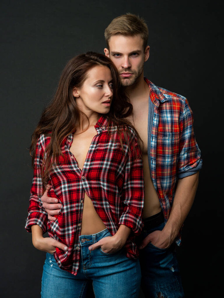 sexy man and woman standing together in checkered shirt, love - Foto, Bild
