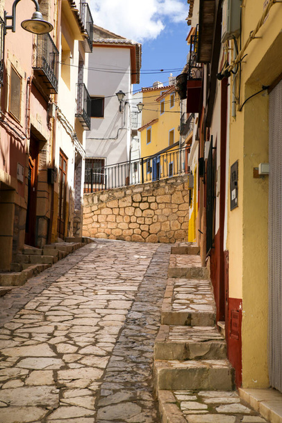 Narrow cobbled street and beautiful facades in Finestrat village, Alicante, Spain - Photo, image