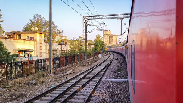 train running on railway track with flat sky at morning from different angle image is taken at new delhi india on Apr 10 2020. - Foto, imagen