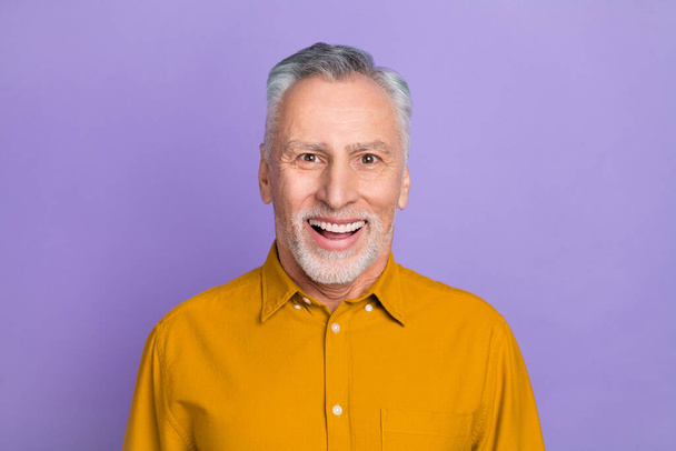 Photo of funky elder white hairdo man wear yellow shirt isolated on violet color background - Valokuva, kuva