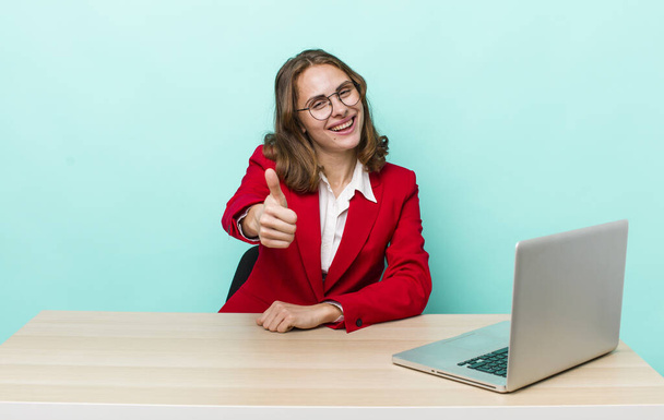 young pretty woman  feeling proud,smiling positively with thumbs up. business concept - Photo, image