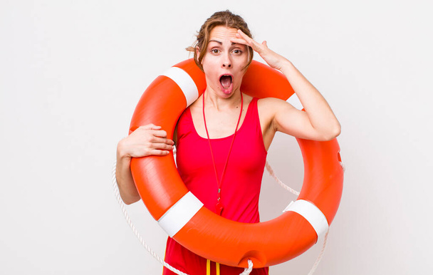 young pretty woman  looking happy, astonished and surprised. lifeguard concept - Foto, imagen