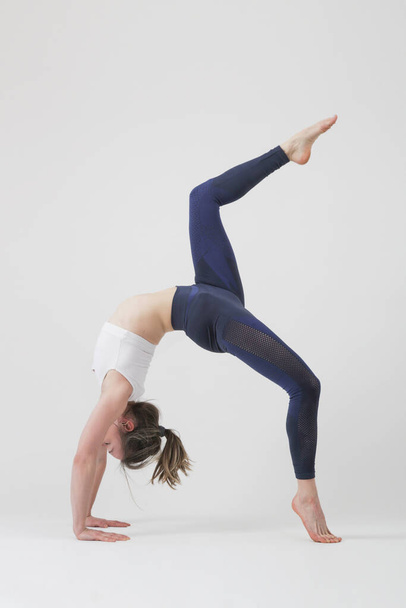 Serie of photos of young fit woman practising yoga. Studio shot on white background. - Fotó, kép