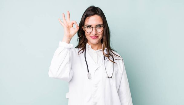 young pretty woman  feeling happy, showing approval with okay gesture. physician concept - Fotografie, Obrázek