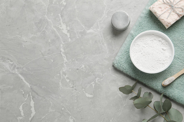 Flat lay composition with tooth powder and eucalyptus on light grey marble table, space for text - Photo, Image