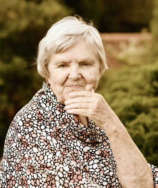 Senior woman in garden - Фото, изображение