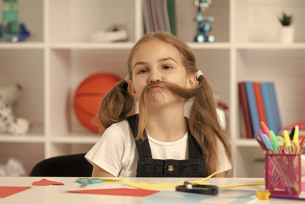 funny child having fun with long hair pony tail at school lesson in classroom wear uniform, fun - Foto, Imagen
