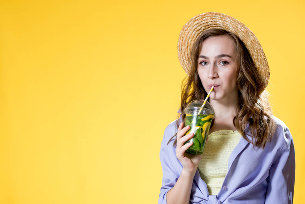 Summer refreshment. Cold beverage. young woman with plastic cup of fresh cocktail Non-alcoholic drink. Detox lemonade. Holiday relax - 写真・画像