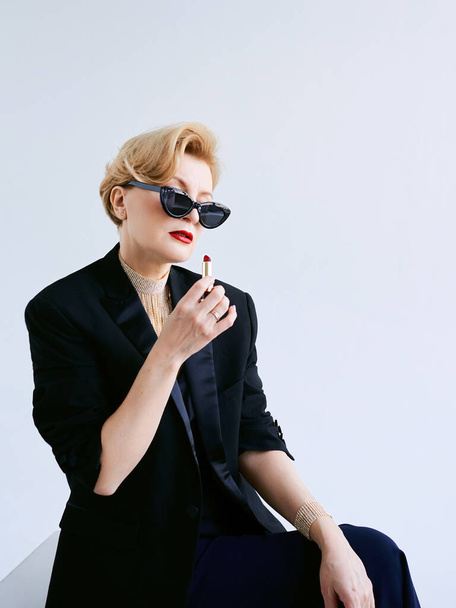 fashionable mature woman in tuxedo with lipstick. Make up, fashion, anti aging concept - Φωτογραφία, εικόνα