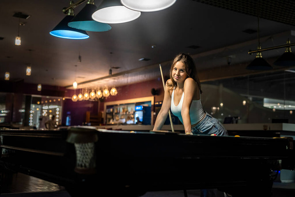 female player playing pool and aiming the billiard ball, lifestyle - Photo, Image