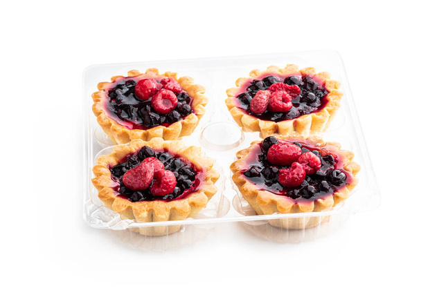 Delicious  fruit tarts in plastic pack isolated on white  - Foto, imagen