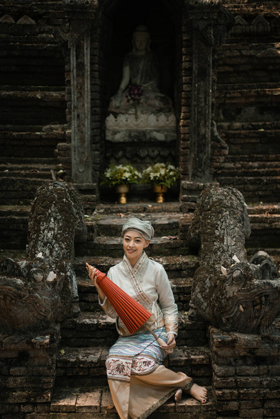 Beautiful Asian women dressed in traditional costumes visit Wat Palad or Wat Pha Lat temple ancient temples pray to the sacred according to Buddhist beliefs in Chiang Mai, Thailand. Religion concept. - Photo, image