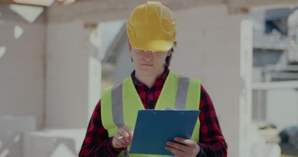 Confident young male contractor holding clipboard - Footage, Video