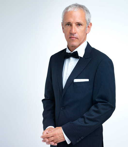 Serious business. A studio shot of a mature man in a tuxedo. - Zdjęcie, obraz
