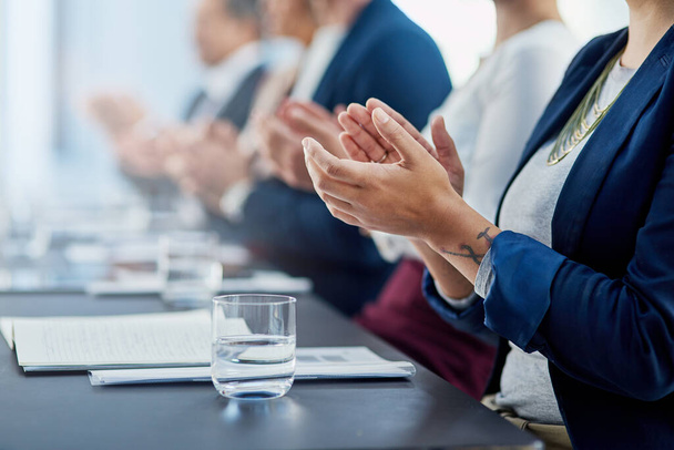 Congratulations on a great presentation. Cropped shot of a group of unidentifiable businesspeople applauding while sitting in the boardroom. - Foto, Imagen