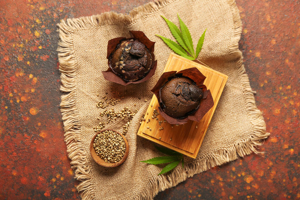 Composition with chocolate hemp muffins and seeds on grunge background - Photo, image