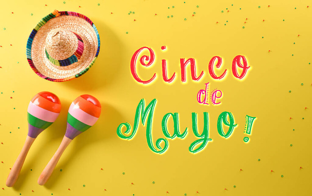 Cinco de Mayo Urlaubshintergrund aus Maracas, Hut und Text auf gelbem Hintergrund. - Foto, Bild
