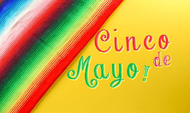 Cinco de Mayo holiday background made from mexican blanket stripes or poncho serape with the text  on yellow background. - Foto, Imagem