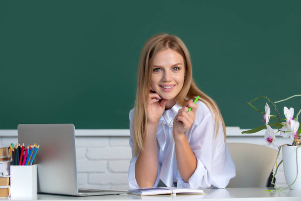 Portrait of smiling young college student studying in classroom. Education, high school, university, learning and people concept. - Foto, Imagen