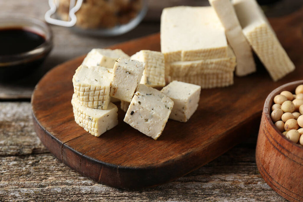 Natural tofu on wooden table, closeup. Soy product - Фото, зображення