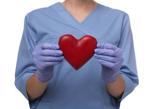 Doctor holding red heart on white background, closeup. Cardiology concept - Fotografie, Obrázek