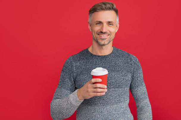 happy man drinking coffee from cup on red background, morning - Foto, immagini