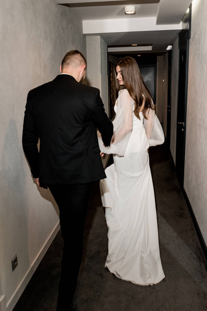 beautiful bride and groom posing in the hallway - Photo, image