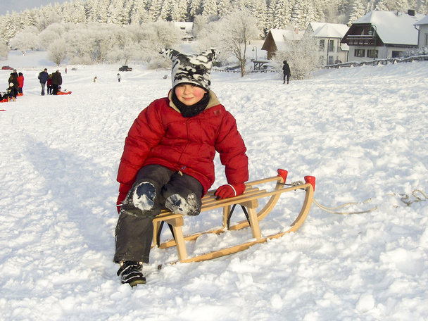 Boy sitting on his sledge - Photo, Image