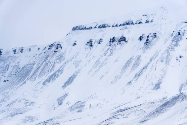 Close-up of a snowy mountain. Northern landscape texture. Norway, Svalbard. - 写真・画像