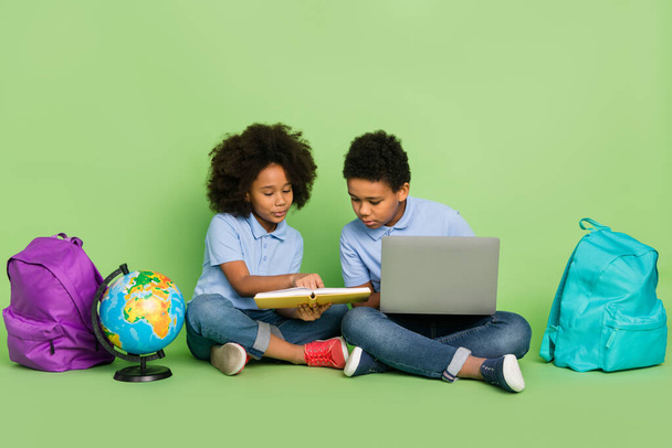 Portrait of attractive pre-teen focused diligent friends friendship doing homework lesson distance isolated on green color background - Foto, Imagen