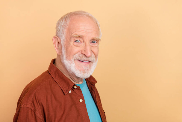 Photo of good aged white hairdo man wear brown shirt isolated on beige color background - Photo, image
