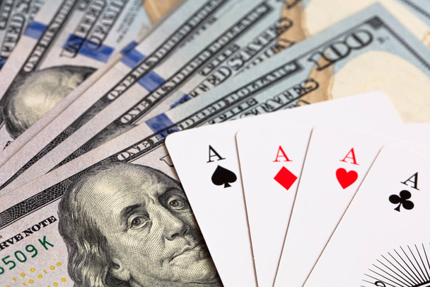 four aces on 100 dollar banknote, concept of winnings and casinos - 写真・画像