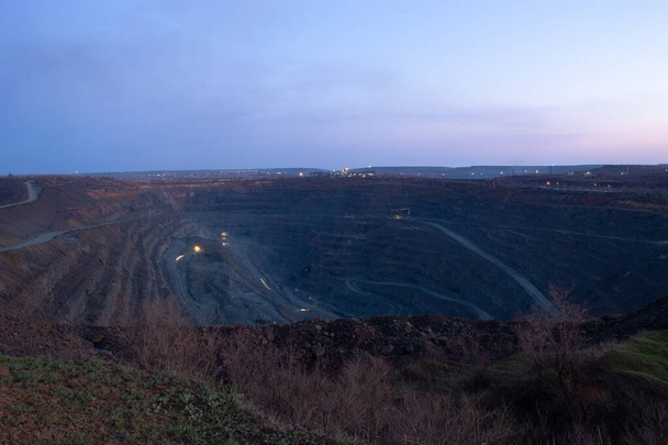 General view of the iron ore quarry. The round-the-clock mining process. Shooting in the evening or in the morning. - Photo, Image