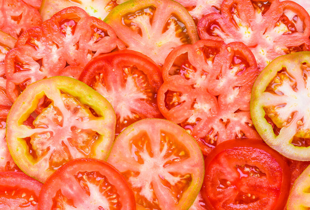 Tomatoes slices close up background. - Foto, afbeelding