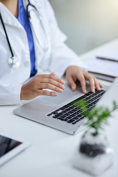 In charge of her medical practice. Closeup shot of a doctor working on a laptop in an office. - Foto, imagen