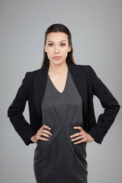 Business is what Im about. Portrait of an attractive young businesswoman standing with her hands on her hips. - Fotografie, Obrázek