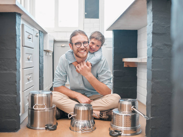 Smiling is definitely one of the best beauty remedies. Shot of a father and son in the kitchen. - Photo, Image