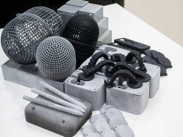 Muchos modelos impresos en impresora 3D. Objetos grises y negros impresos impresora 3D. - Foto, imagen