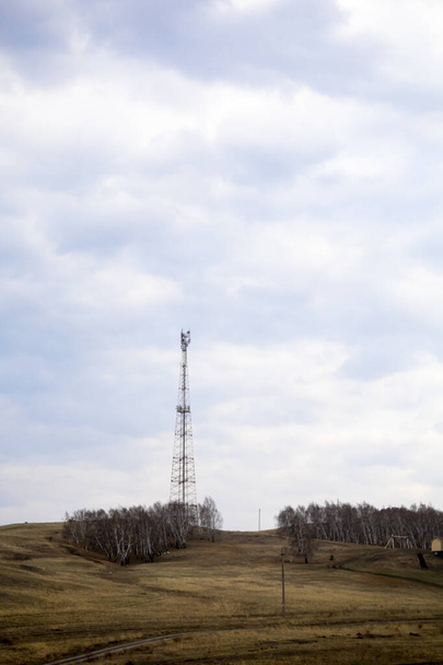 A lonely TV tower stands on a mountain. - 写真・画像