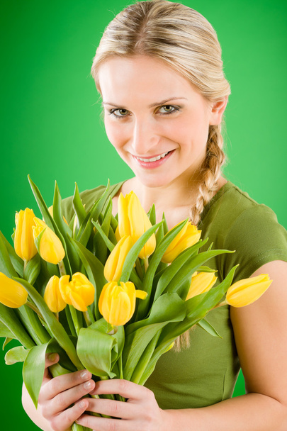 Young woman hold yellow tulips flower - 写真・画像